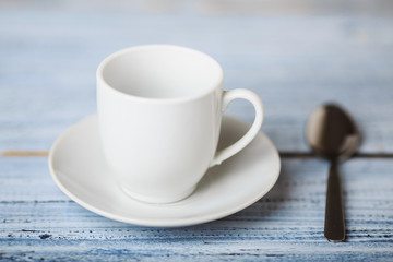 white coffe cup on light wooden background