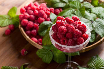 Ice cream with juicy red raspberies .