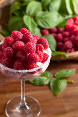 Ice cream with juicy red raspberies .