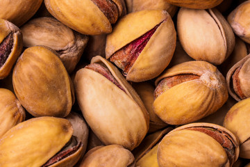 Close-up of pistachio. Selective focus on foreground.Pistachios texture. Nuts. Roasted salted pistachio nuts healthy delicious food studio photo.