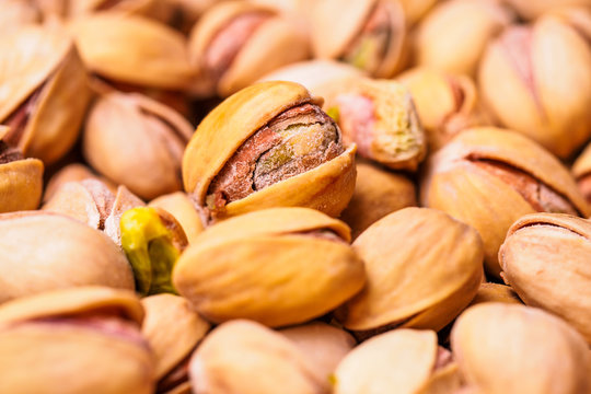 Close-up of pistachio. Selective focus on foreground.Pistachios texture. Nuts. Roasted salted pistachio nuts healthy delicious food studio photo.