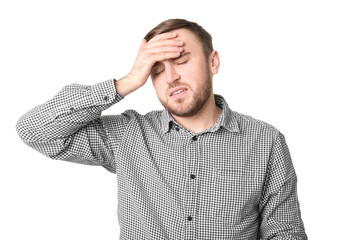 Young man suffering from headache on white background