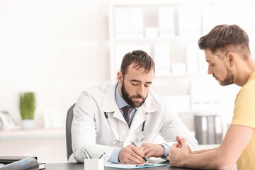 Doctor consulting male patient in clinic