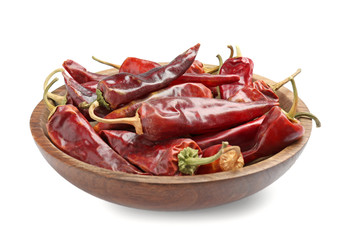 Plate with dry chili pepper on white background