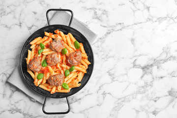 Pasta with meatballs and tomato sauce on light background