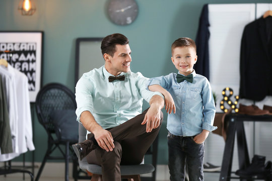 Stylish father and son in shirts, indoors