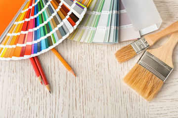Flat lay composition with color palette and brushes on table