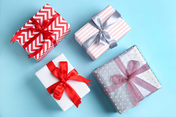 Different gift boxes on color background, flat lay