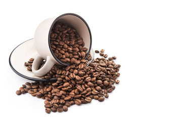 ceramic cup filled with roasted coffee beans