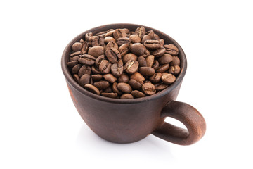 ceramic cup filled with roasted coffee beans