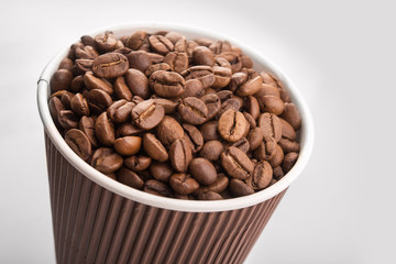 paper cup filled with coffee beans