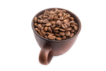 ceramic cup filled with roasted coffee beans