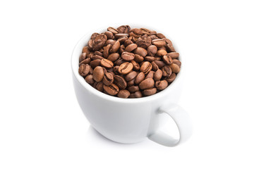 ceramic cup filled with roasted coffee beans