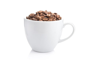 ceramic cup filled with roasted coffee beans