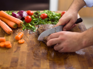 closeup of Chef hands preparing beef steak