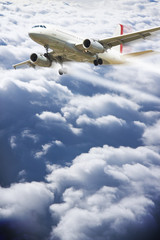 Fototapeta na wymiar Airplane flying above the clouds - concept image with copy space