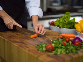 chef hands cutting carrots