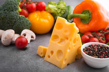 piece of cheese with fresh vegetables
