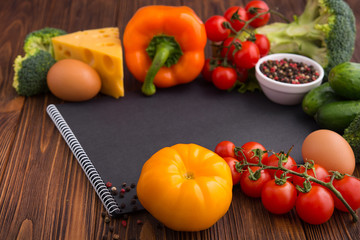 Black recipe notebook with tomato, papper, cheese