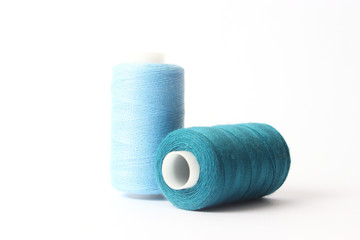 sewing thread of different colors isolated on white.