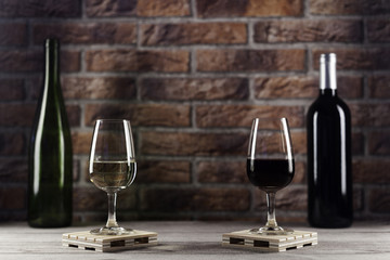 Red and white wine glasses and bottles