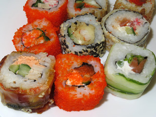 Various kinds of sushi rolls on white background