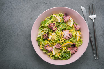 Fresh salad with octopus, lettuce and lemon