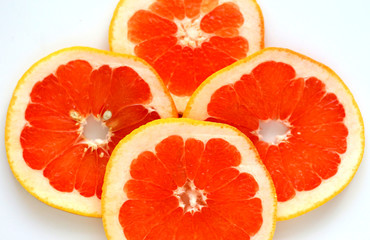 sliced grapefruit on a white background