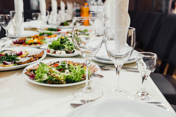 catering table set service with silverware and glass stemware at
