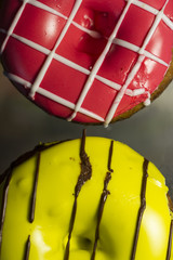 Two donuts. Pink and Yellow