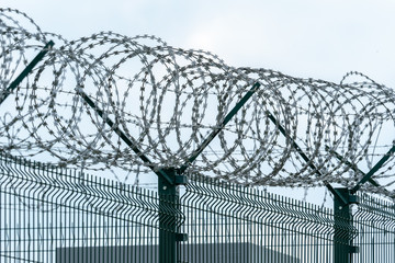 Security fence with a barbed wire. Fence with a barbed wire.