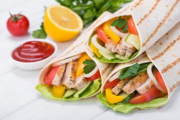 Tortilla wraps with grilled chicken and fresh vegetables