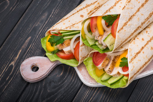 Tortilla wraps with grilled chicken and fresh vegetables