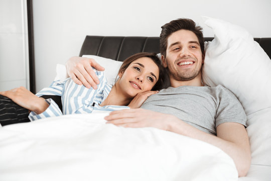 Portrait of a smiling young couple lying