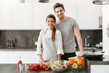 Portrait of a happy young couple cooking together