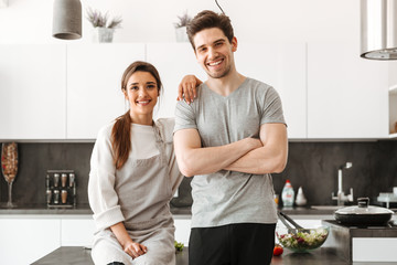 Portrait of a happy young couple at the kitchen