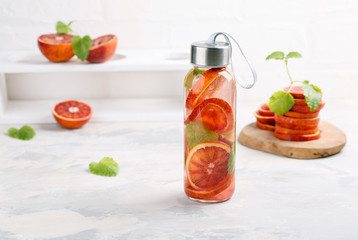 Detox infused water flavored with bloody orange and mint. Healthy refreshing beverage.