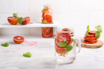 Detox infused water flavored with bloody orange and mint. Healthy refreshing beverage.