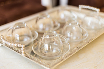 Close up of many empty glasses on luxury tray in restaurant.