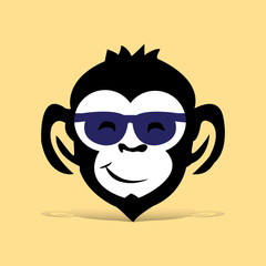 Head of black monkey with glasses, cartoon on light brown background,