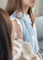 Immunization and medical vaccination for flu shot, influenza or HPV prevention with adult woman...