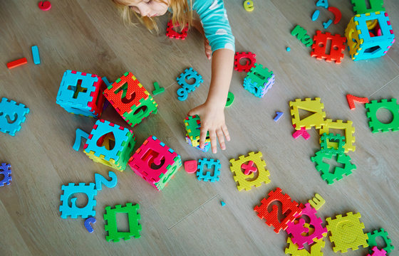 little girl learning numbers and shapes, play with puzzle