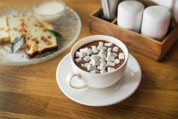 White coffee cup with dessert marshmallow