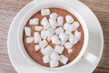 Fototapeta na wymiar White coffee cup with dessert marshmallow