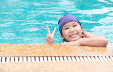 Happy little girl smile and wear swimming cap