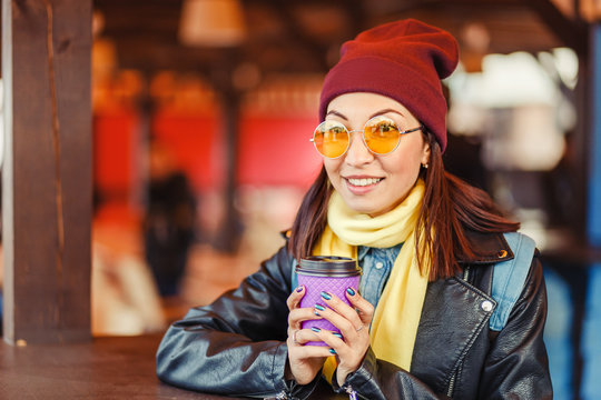 Hipster stylish woman drink takeaway hot coffee at outdoor cafe