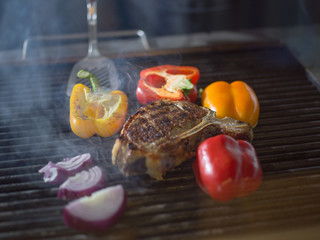 steak with vegetables on a barbecue