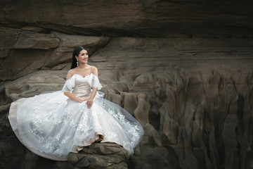 Portrait of asian bride on the rock