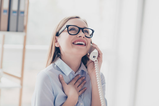 Portrait of positive, smiling, cheerful, pretty, stylish woman with in glasses speaking with lover on phone, having break, timeout, fun in workplace, workstation