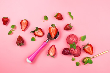 Fresh organic strawberries, sorbet balls, mint leaves and ice cream spoon on pink, pastel background, flatlay